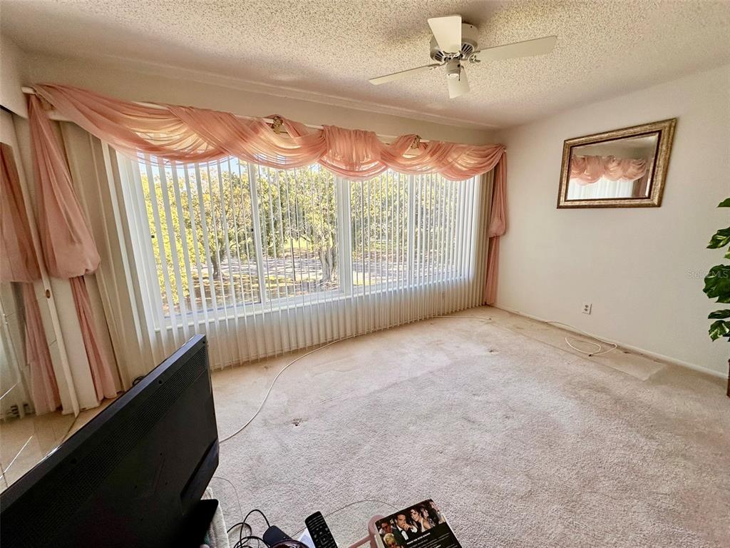2340 Grecian Way, Unit 56 Clearwater, FL 33763 - Photo 7 of 40 wooden floor in an empty room with a window