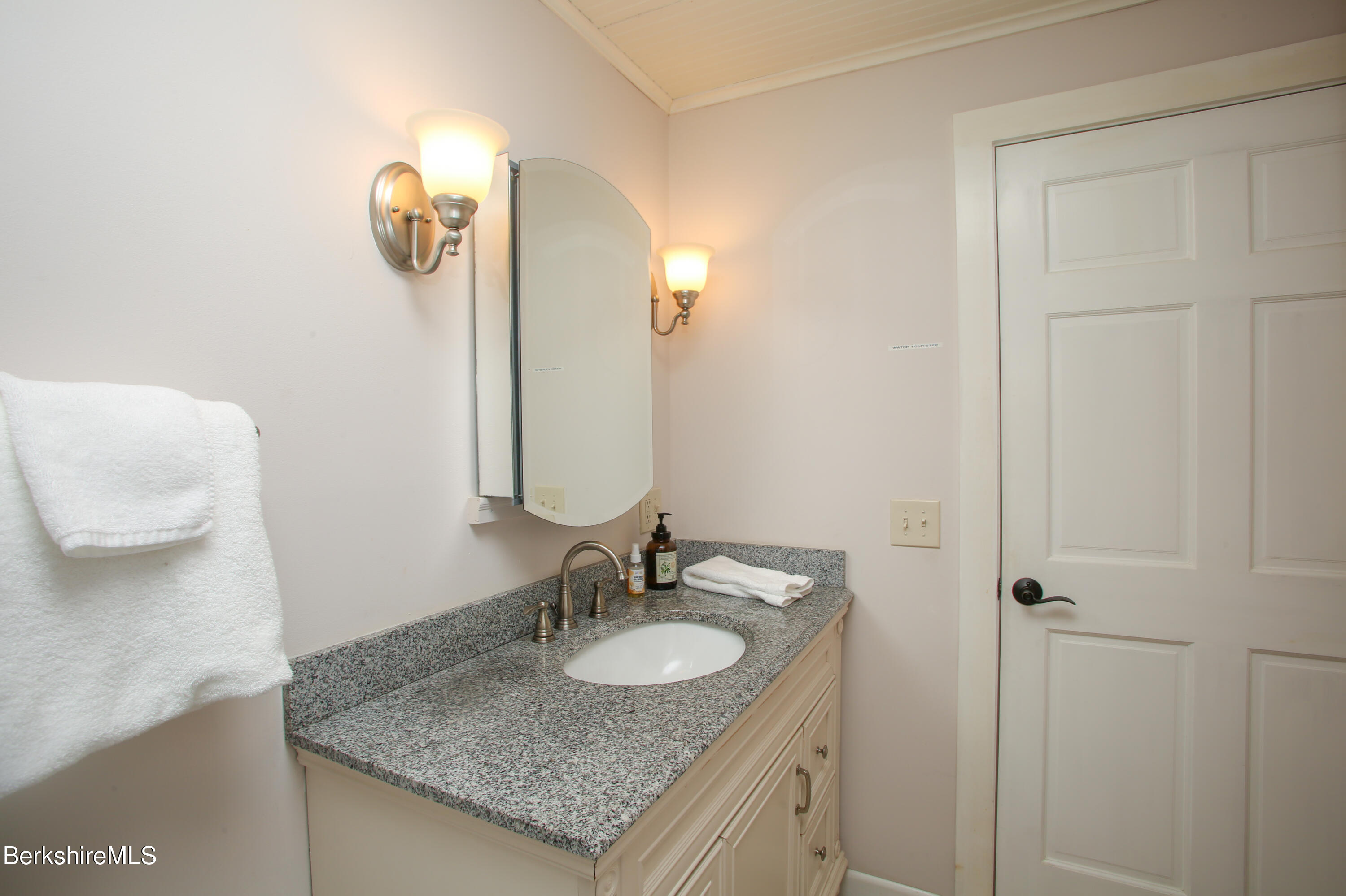 127 County Road Rowe, MA 01367 - Photo 18 of 29 a bathroom with a granite countertop sink and a mirror