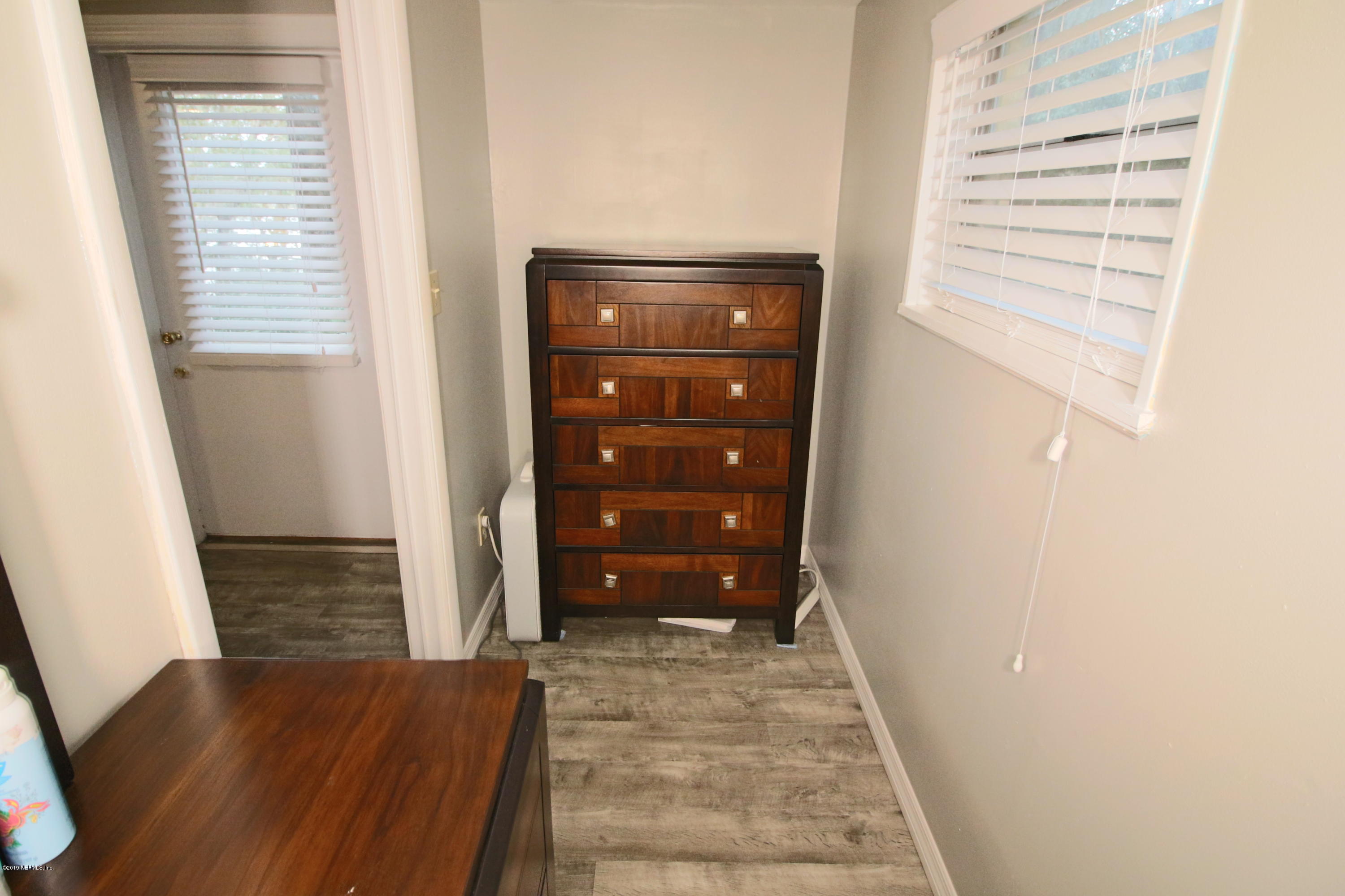 6606 Brooklyn Bay Road Keystone Heights, FL 32656 - Photo 39 of 62 a view of walk in closet with wooden floor
