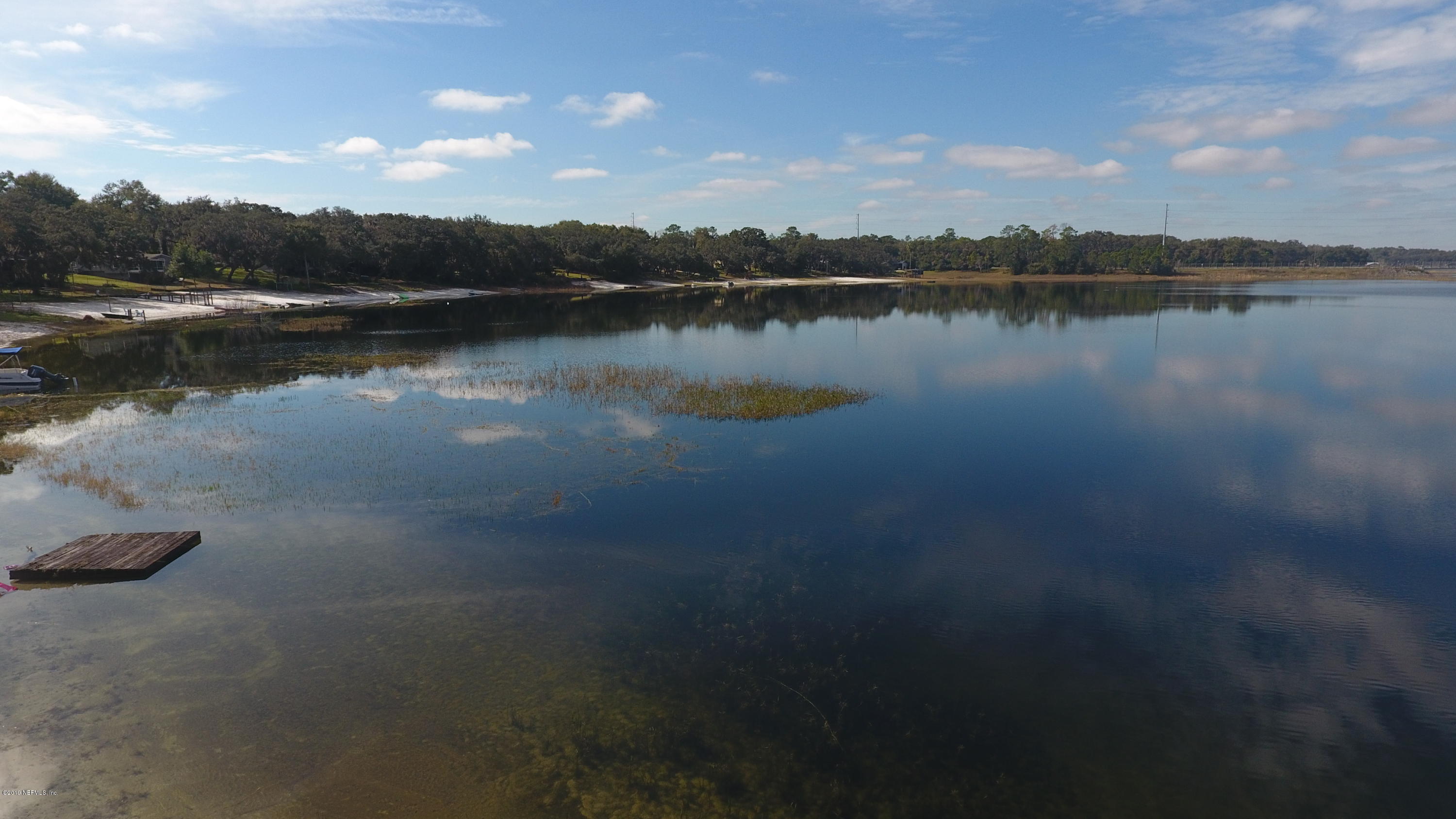 6606 Brooklyn Bay Road Keystone Heights, FL 32656 - Photo 60 of 62 a view of a lake with houses in the back