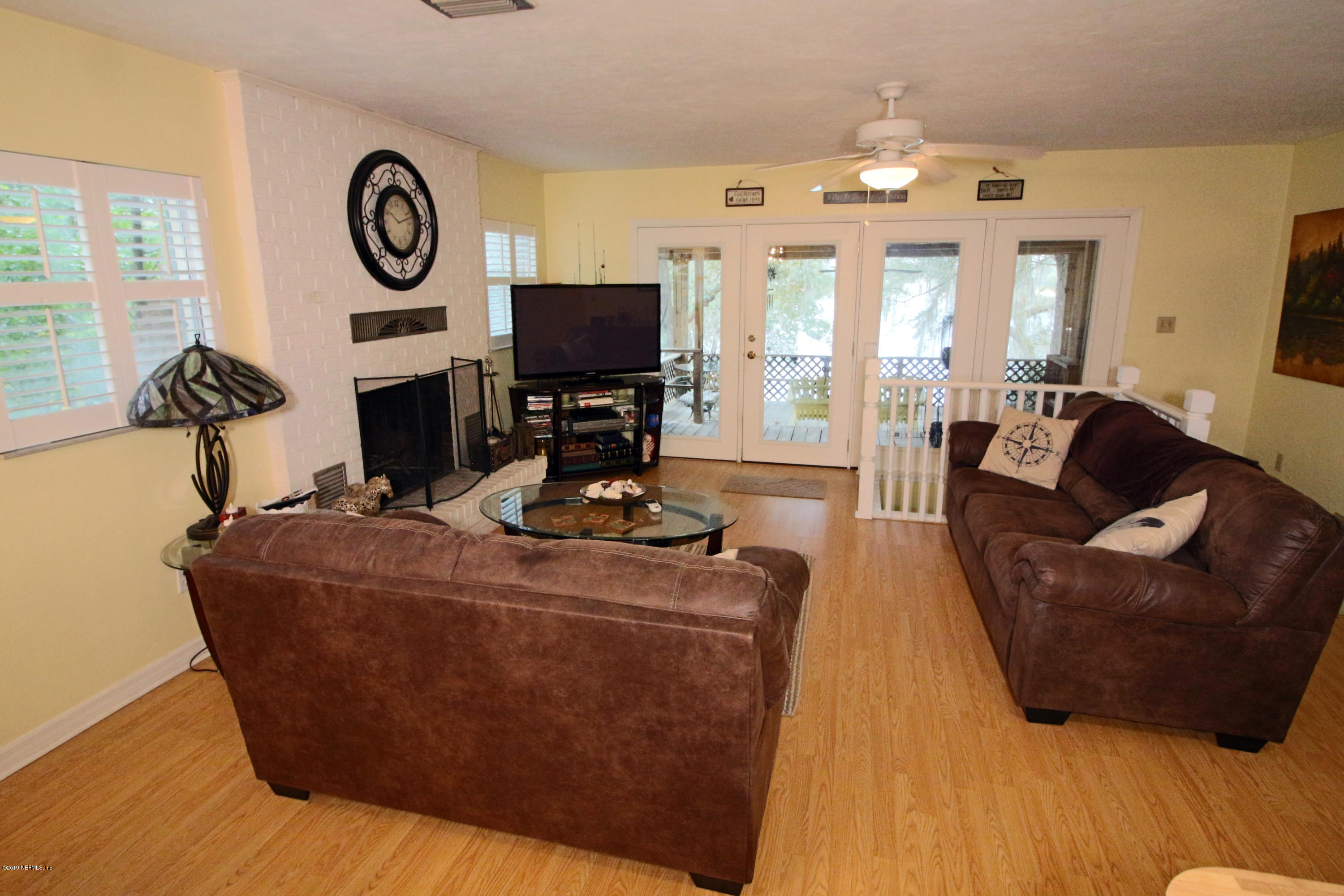 6606 Brooklyn Bay Road Keystone Heights, FL 32656 - Photo 10 of 62 a living room with furniture a large window and a flat screen tv