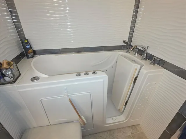 a bedroom with a bed couch and window