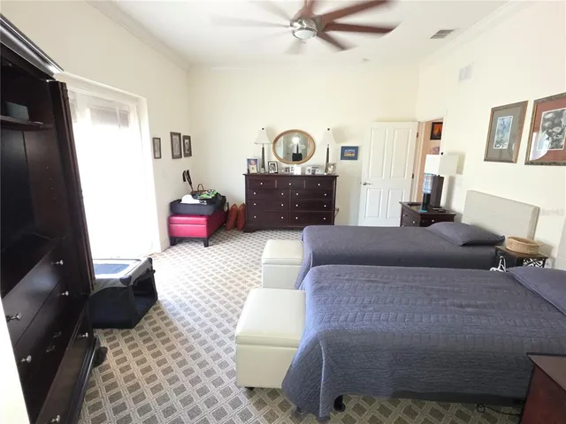 a bedroom with furniture and a flat screen tv