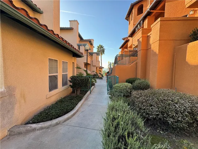 a view of a house with backyard and iron fence