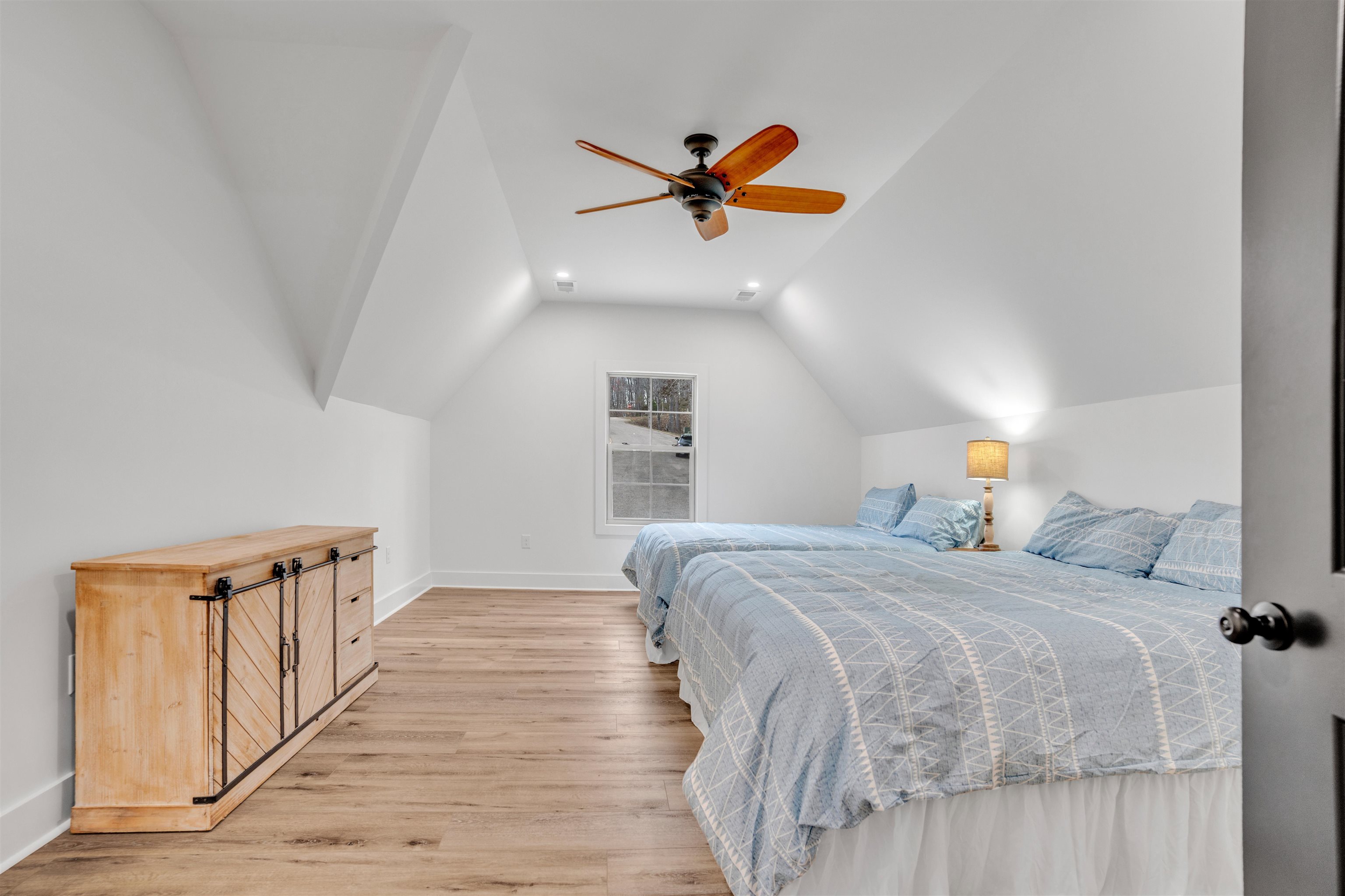 70 Native Leaf Cove Savannah, TN 38372 - Photo 25 of 40 a bedroom with a bed and a chandelier