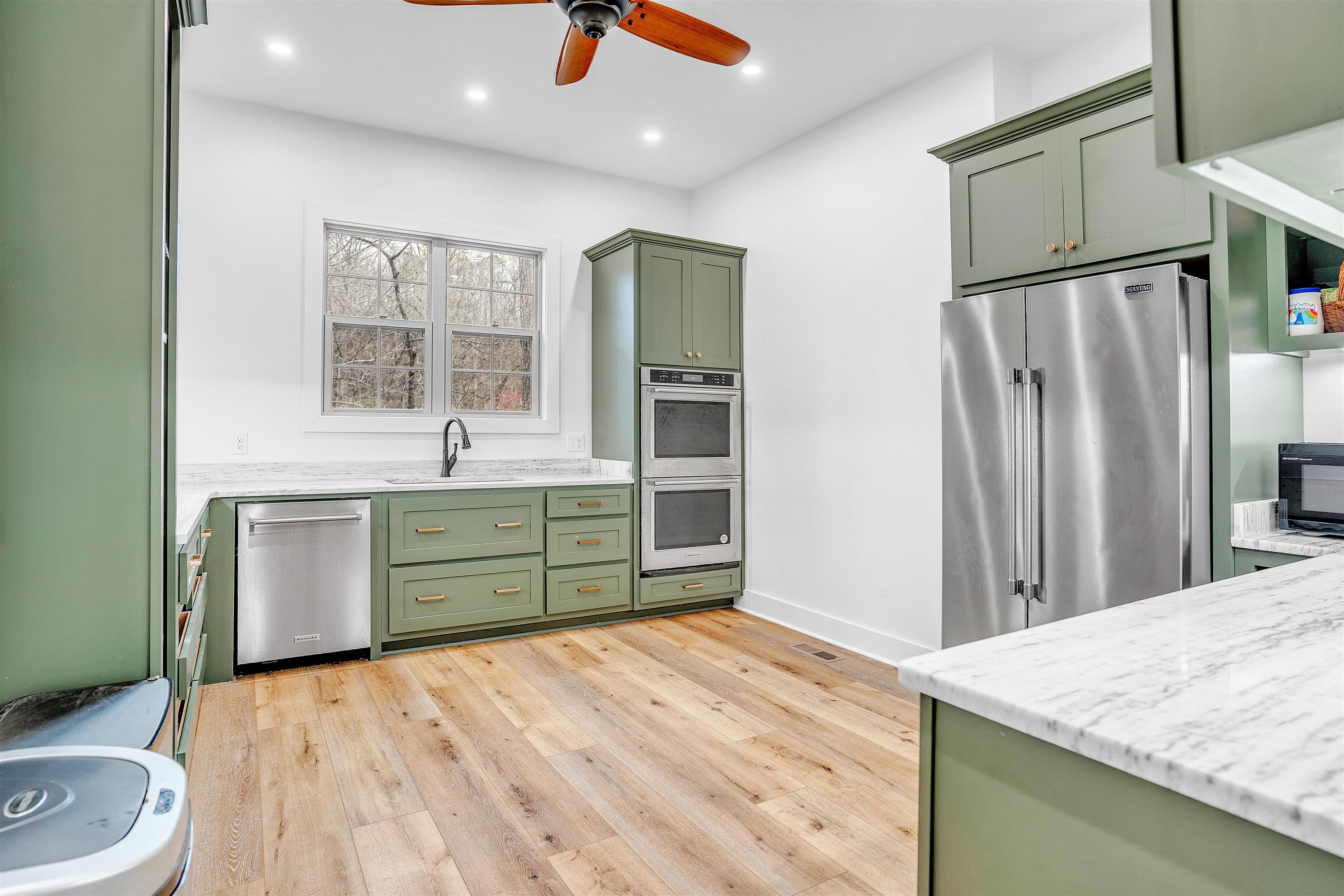 70 Native Leaf Cove Savannah, TN 38372 - Photo 9 of 40 a kitchen with a refrigerator and a sink