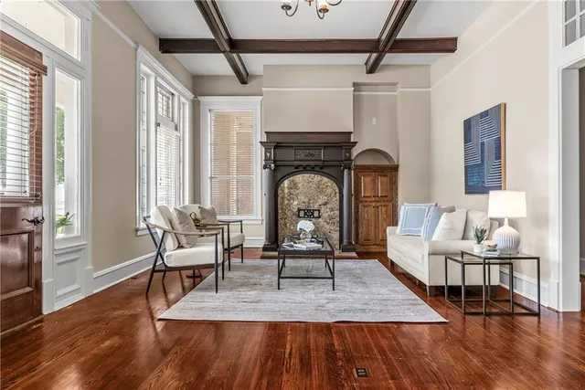 a living room with furniture a chandelier and a window