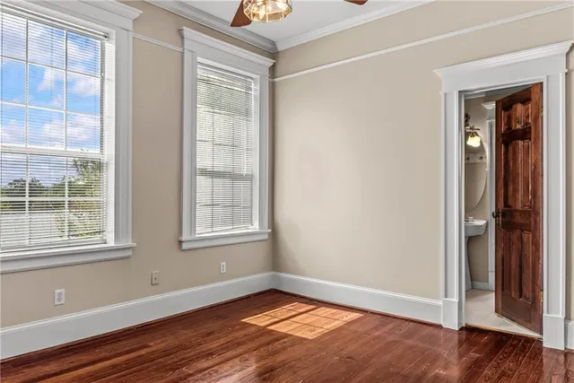 a view of a large pool with a yard and plants and large trees