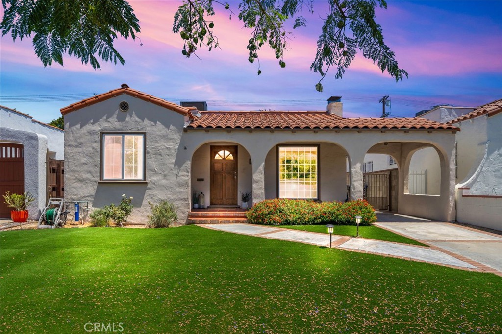 a front view of a house with a garden