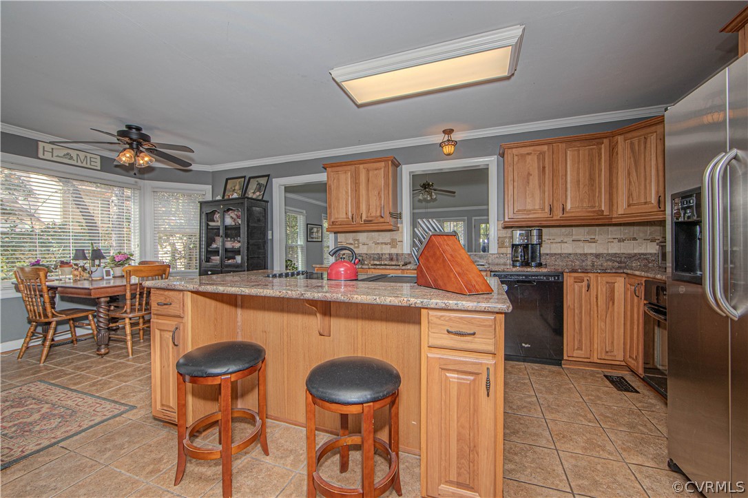 13717 Winterberry Ridge Midlothian, VA 23112 - Photo 7 of 29 a kitchen with stainless steel appliances granite countertop a stove a sink a refrigerator and chairs