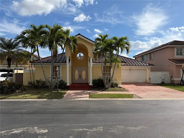 a house with palm tree in front of it