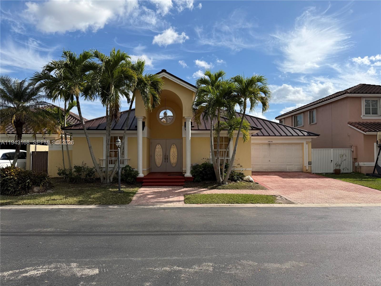 a house with palm tree in front of it