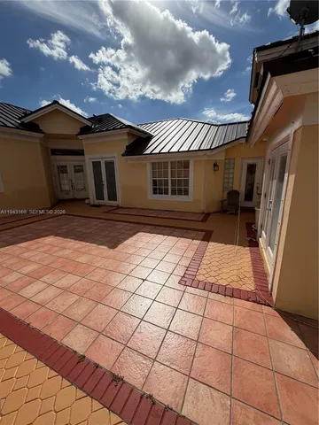 a view of a house with wooden fence and a porch