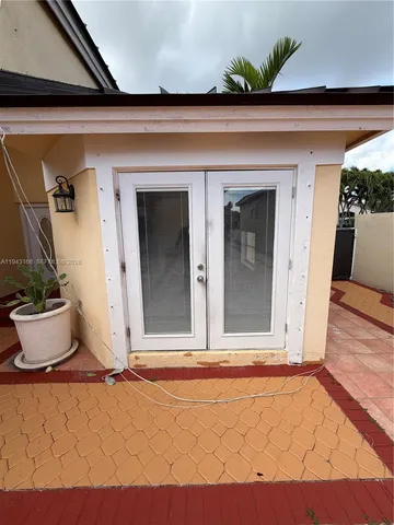 a kitchen with stainless steel appliances kitchen island wooden floors stove and sink