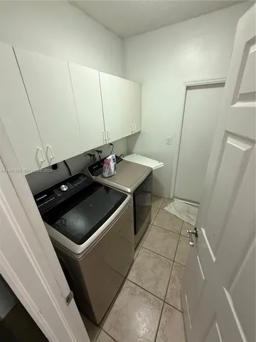 a large bathroom with a double vanity sink a toilet a mirror and shower