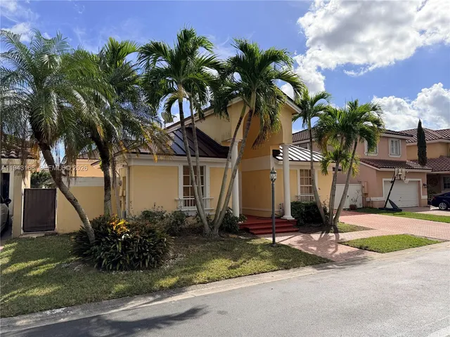 a front view of house with yard and green space