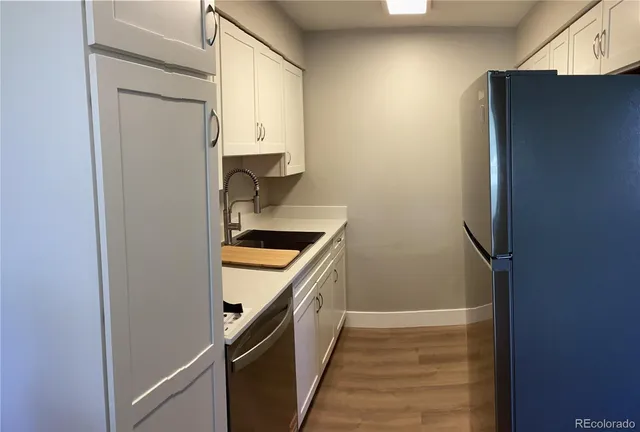 a kitchen with a refrigerator and a stove