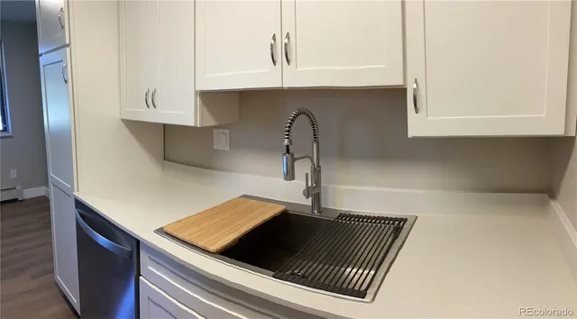 a close view of a sink and a stove in the kitchen