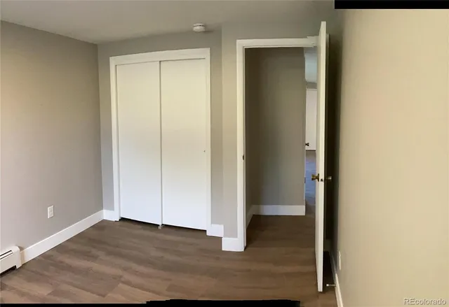 an empty room with wooden floor