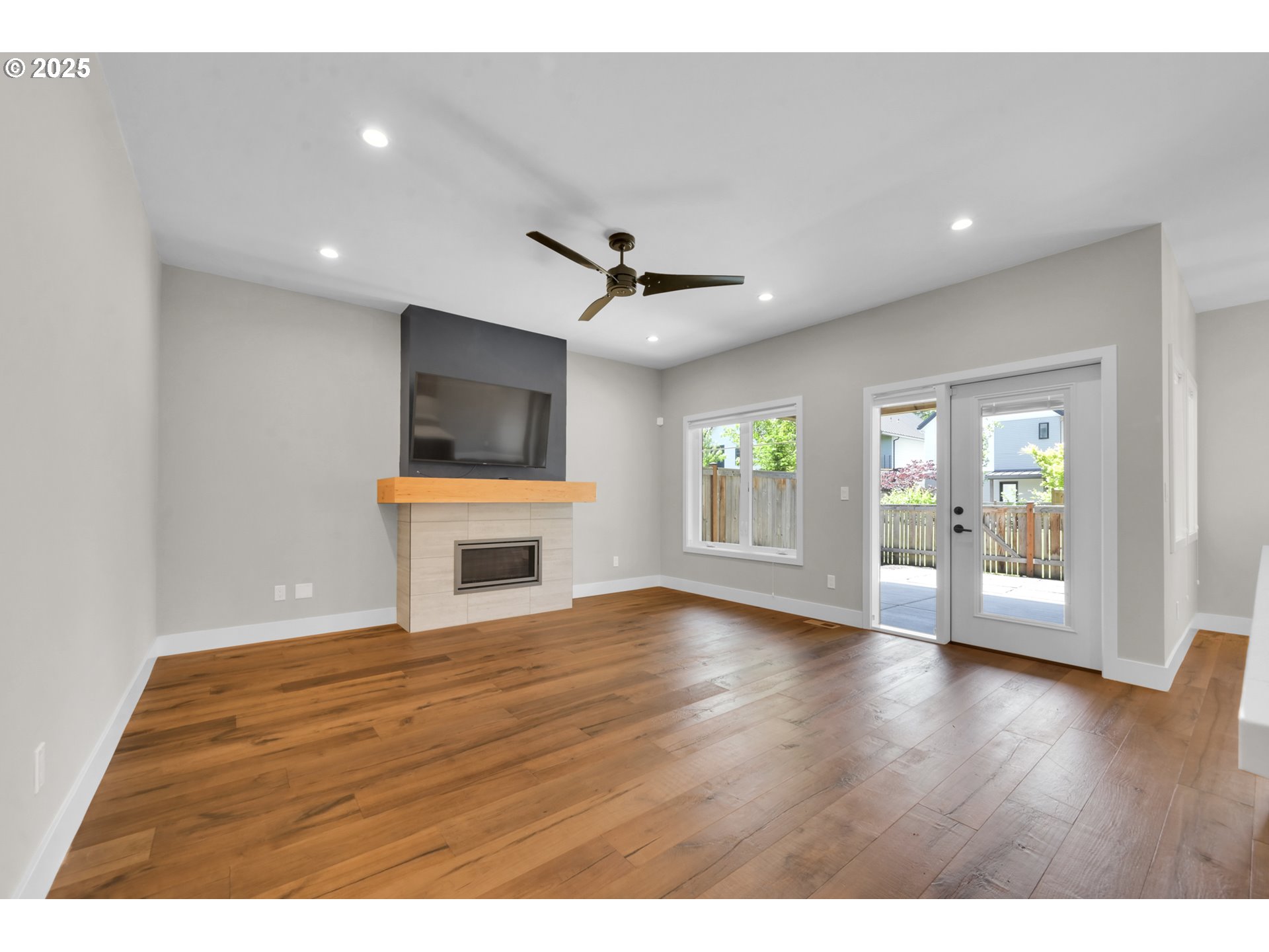 1915 Elkhorn Drive Eugene, OR 97408 - Photo 4 of 28 a view of an empty room with a window and wooden floor