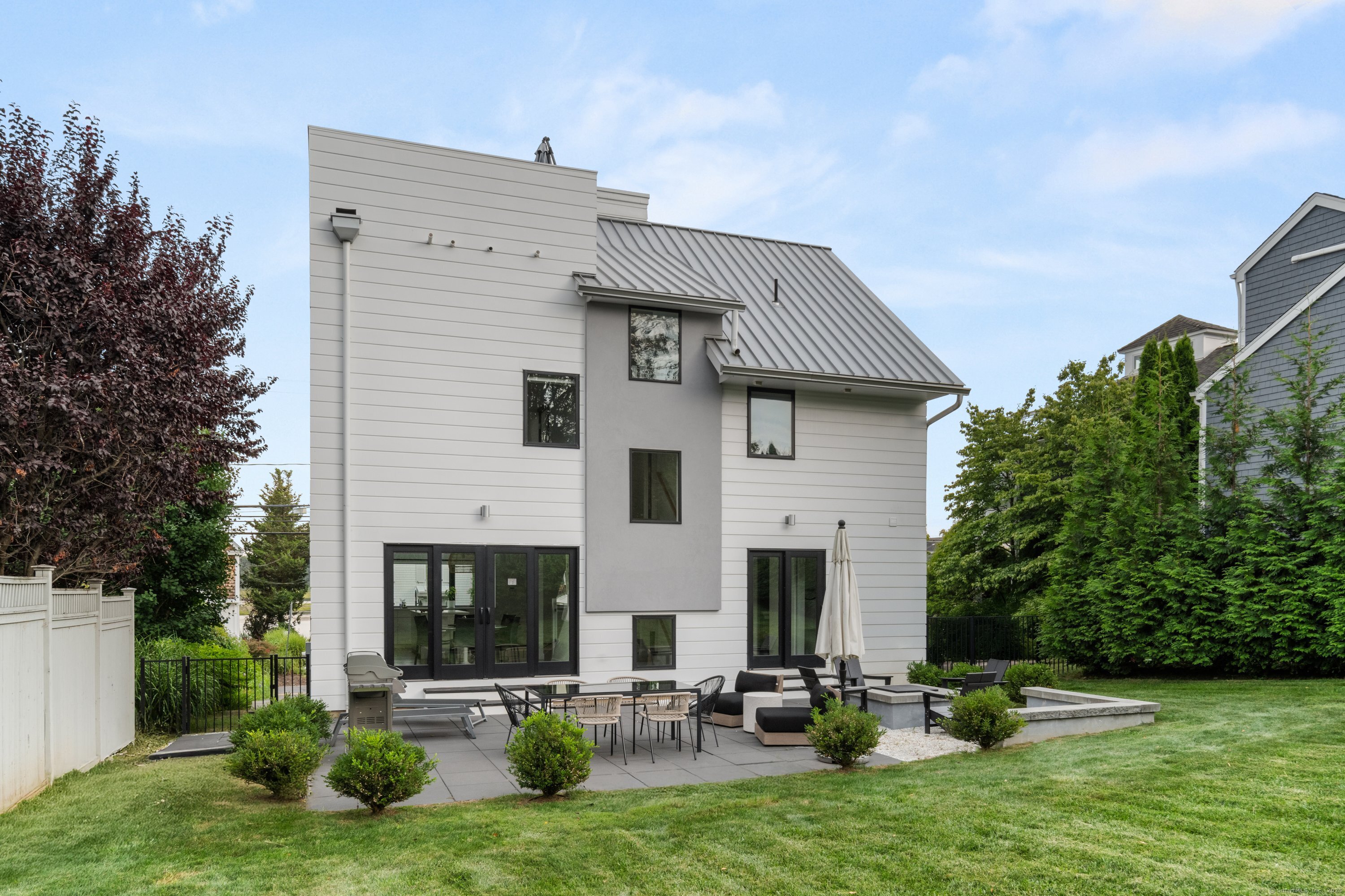 200 Hillspoint Road Westport, CT 06880 - Photo 2 of 37 a view of a house with backyard and sitting area