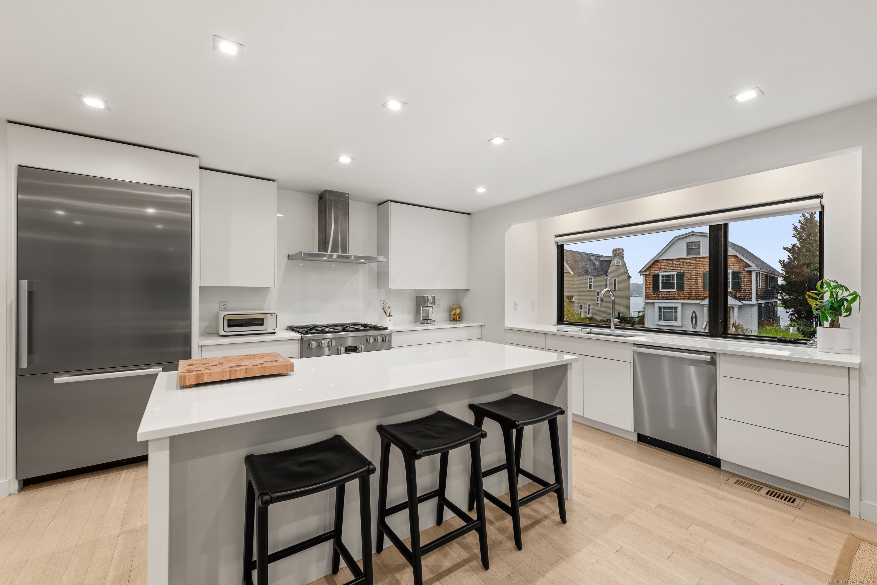 200 Hillspoint Road Westport, CT 06880 - Photo 8 of 37 a kitchen with a sink and chairs