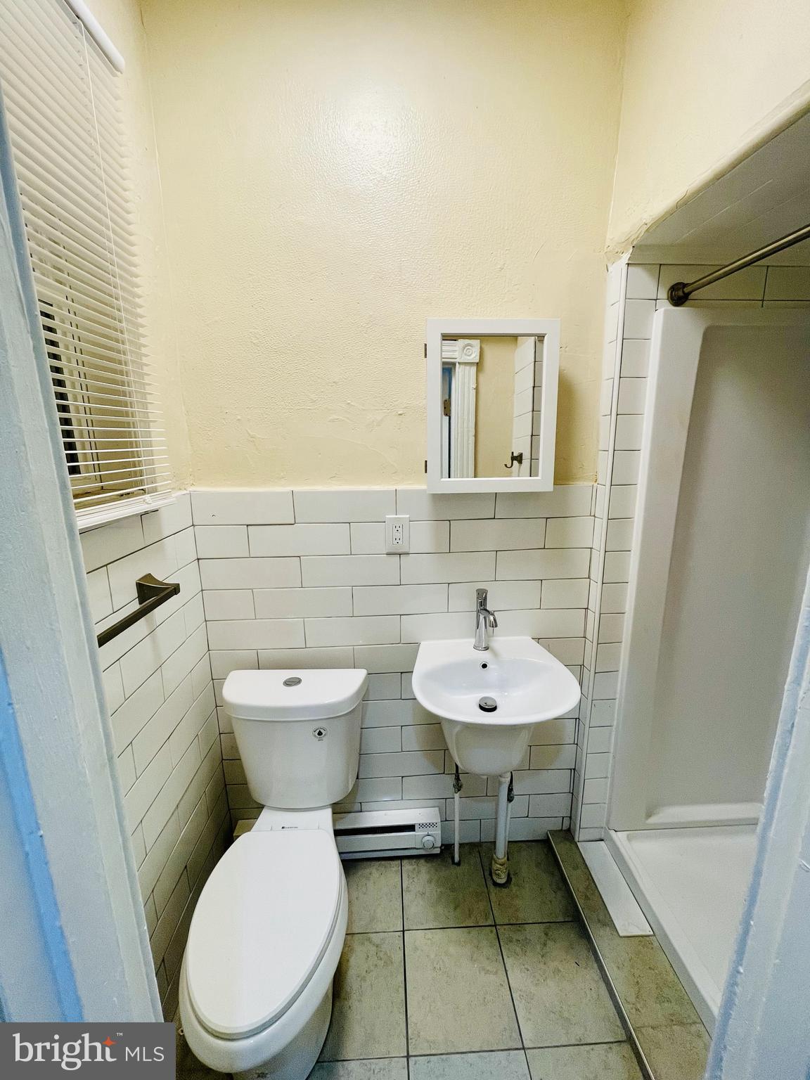 3151 G Street, Unit A Philadelphia, PA 19134 - Photo 6 of 6 a bathroom with a toilet a sink and a mirror