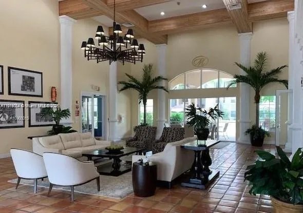 a living room with furniture a chandelier and a chandelier