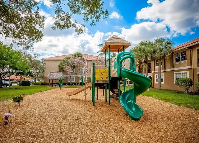 a view of a park with iron fence
