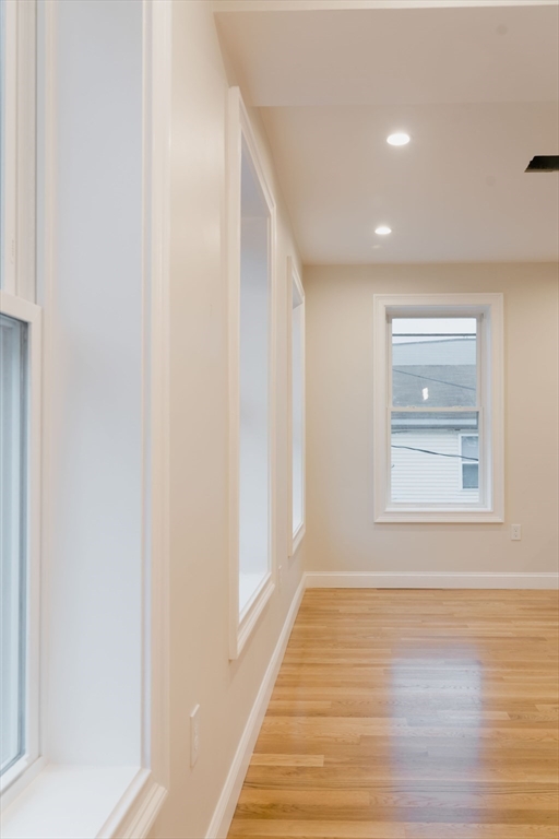 217 West 9th Street, Unit 2 Boston, MA 02127 - Photo 12 of 14 a view of an empty room with wooden floor and a window