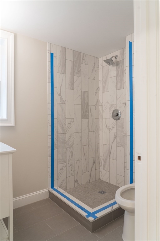 217 West 9th Street, Unit 2 Boston, MA 02127 - Photo 14 of 14 a bathroom with a shower and toilet