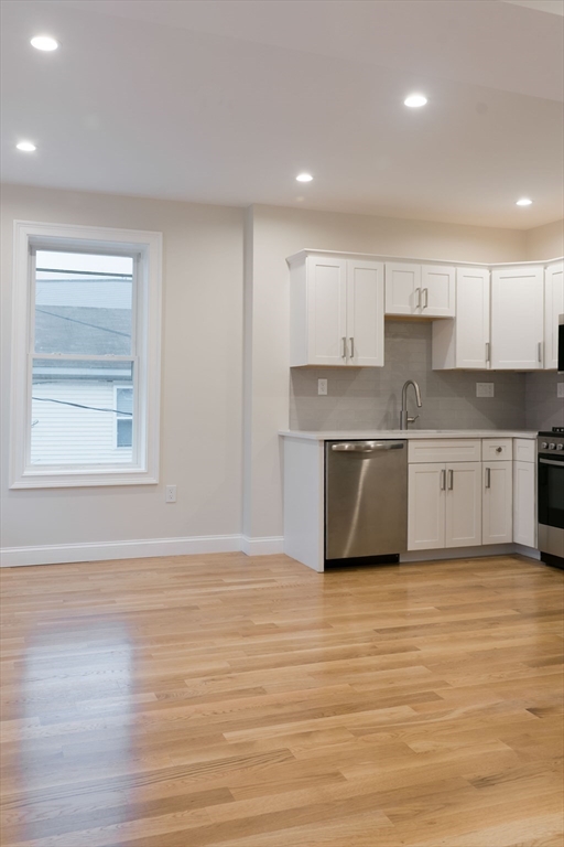 217 West 9th Street, Unit 2 Boston, MA 02127 - Photo 5 of 14 a view of kitchen with wooden floor