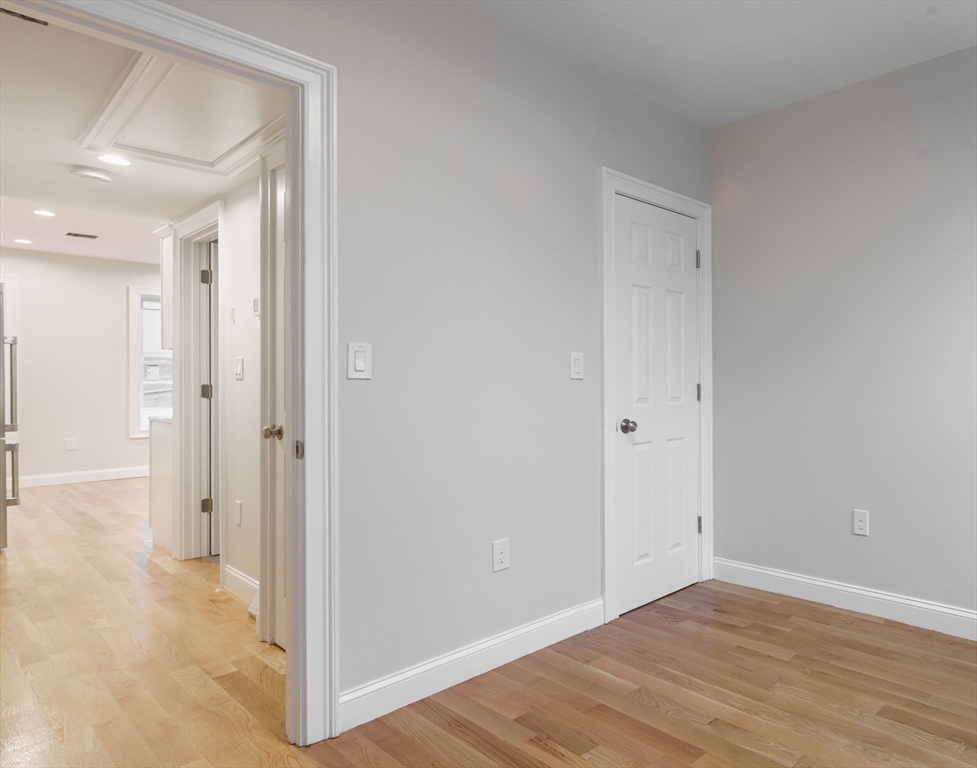 217 West 9th Street, Unit 2 Boston, MA 02127 - Photo 9 of 14 a view of a hallway with wooden floor