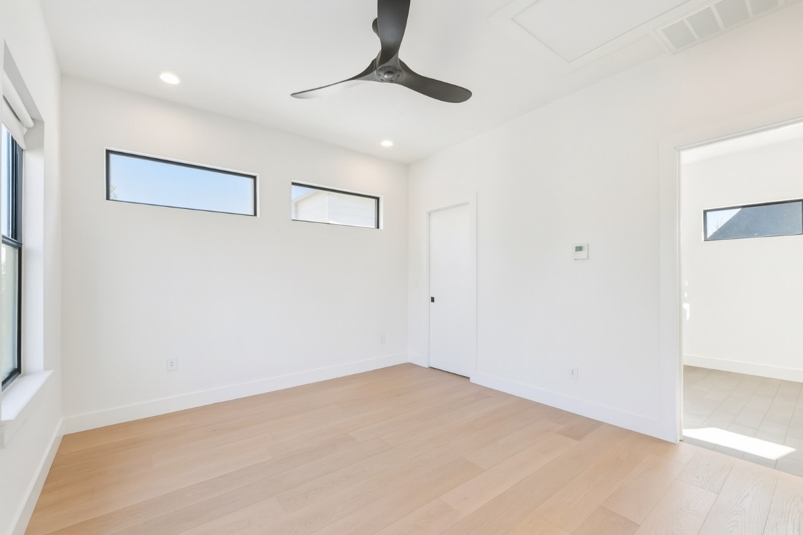 2916 East 13th Street, Unit 2 Austin, TX 78702 - Photo 13 of 35 Empty room with ceiling fan, light wood-style floors, and recessed lighting