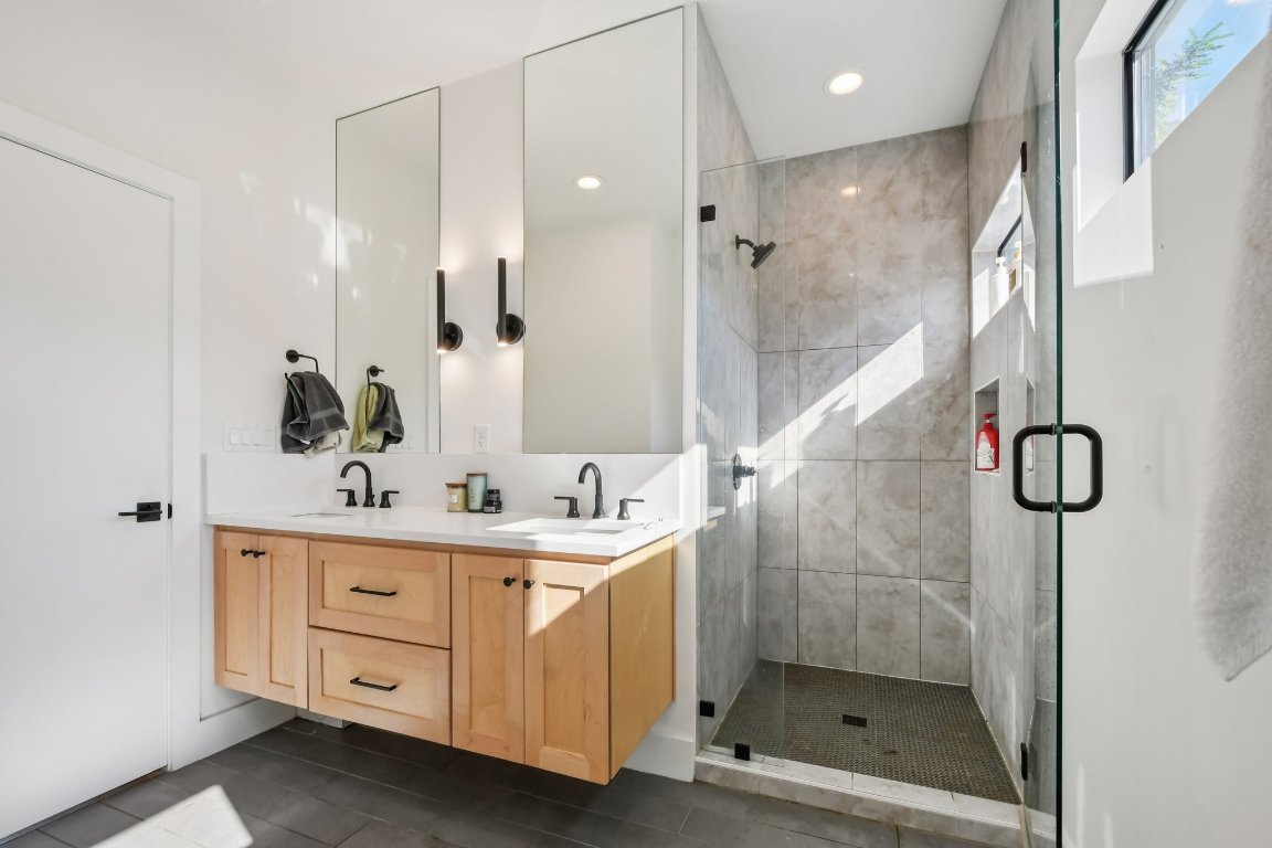 2916 East 13th Street, Unit 2 Austin, TX 78702 - Photo 15 of 35 Full bath with double vanity, a stall shower, and recessed lighting