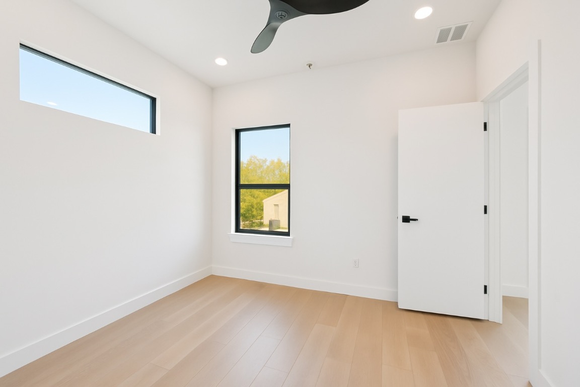 2916 East 13th Street, Unit 2 Austin, TX 78702 - Photo 19 of 35 Unfurnished bedroom featuring light wood-type flooring, recessed lighting, and a ceiling fan
