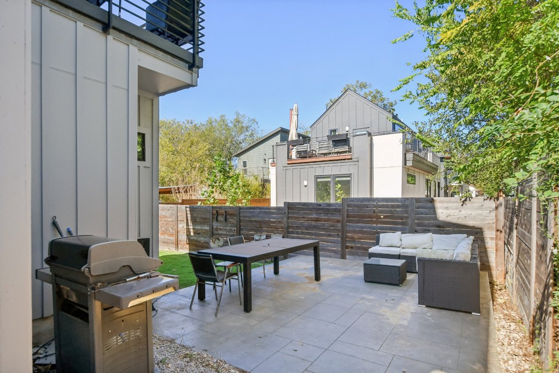 2916 East 13th Street, Unit 2 Austin, TX 78702 - Photo 30 of 35 Fenced backyard featuring a patio area, a grill, an outdoor hangout area, and outdoor dining space