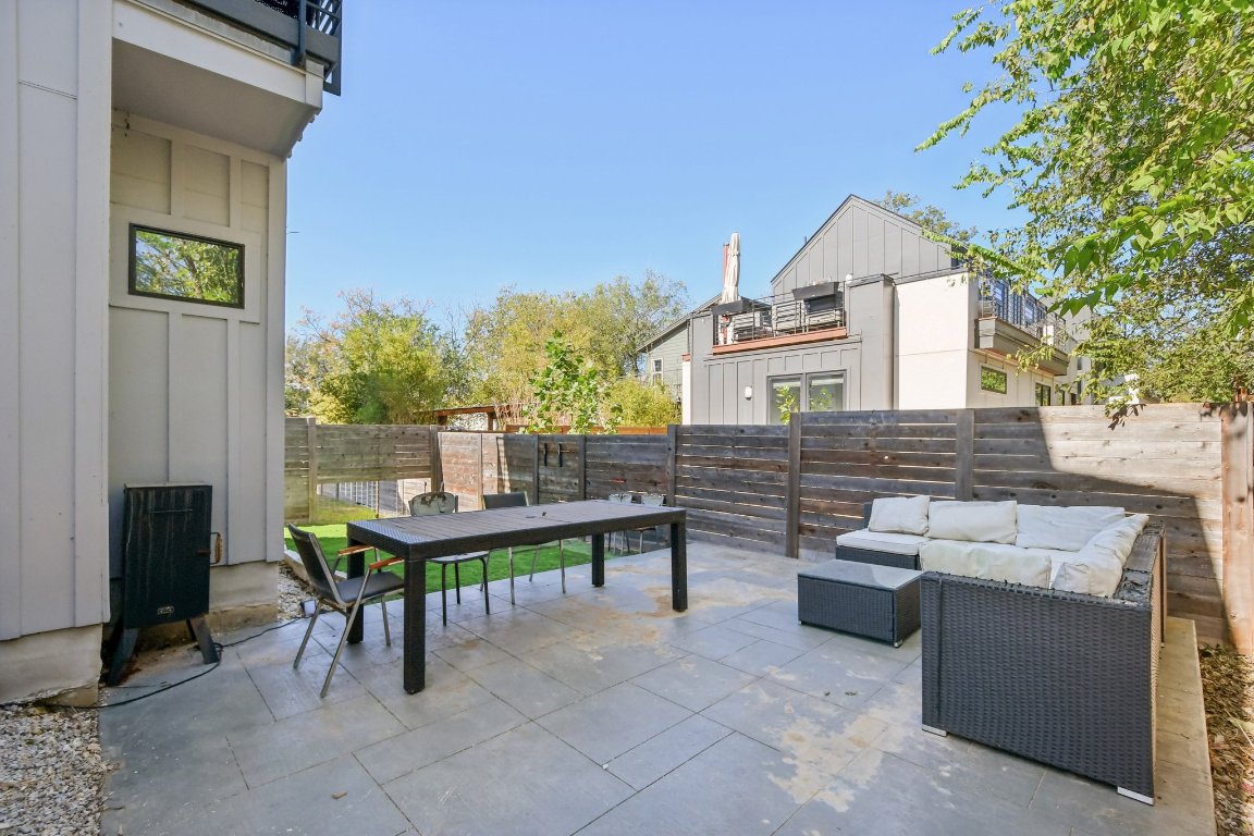 2916 East 13th Street, Unit 2 Austin, TX 78702 - Photo 31 of 35 Fenced backyard with a patio, an outdoor living space, and outdoor dining area