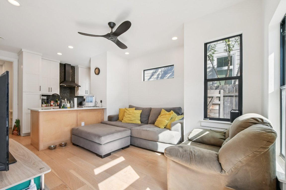 2916 East 13th Street, Unit 2 Austin, TX 78702 - Photo 6 of 35 Living room featuring light wood-style floors, healthy amount of natural light, recessed lighting, and ceiling fan