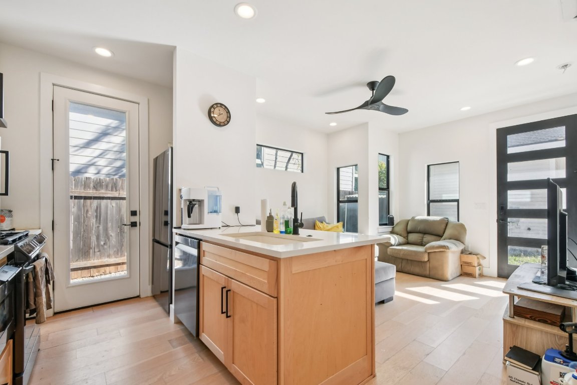 2916 East 13th Street, Unit 2 Austin, TX 78702 - Photo 34 of 35 Kitchen with light brown cabinets, a peninsula, open floor plan, light wood-style floors, and recessed lighting