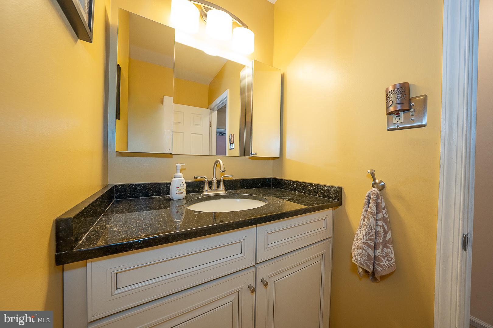 848 Mourning Dove Road Audubon, PA 19403 - Photo 40 of 86 a bathroom with a granite countertop sink and a mirror