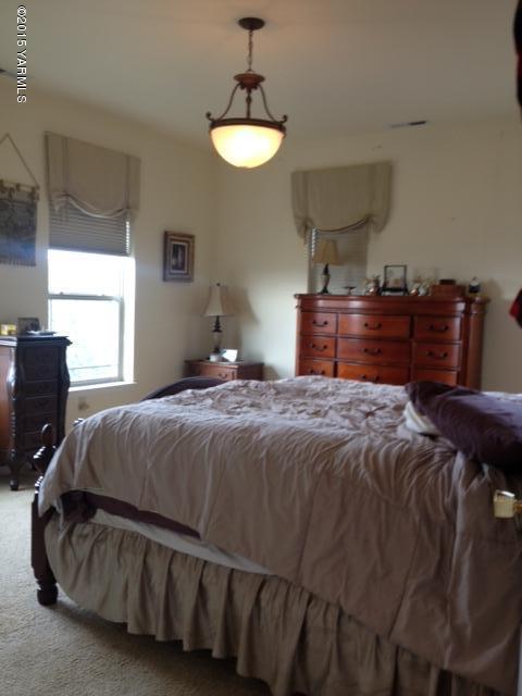 507 Ballard Road Zillah, WA 98953 - Photo 8 of 11 a bedroom with a bed and dresser