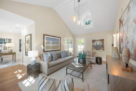 a living room with furniture and a chandelier