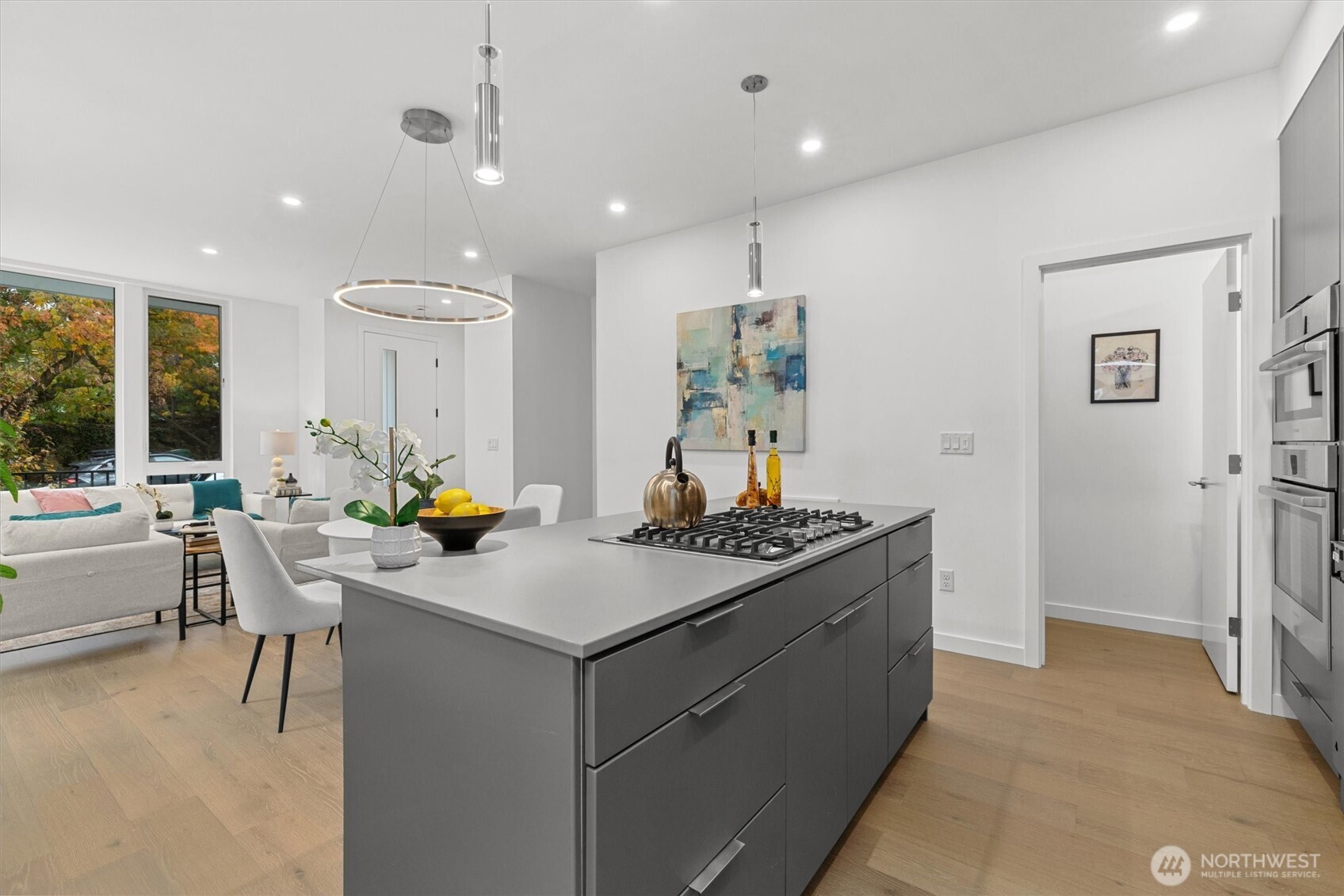 2009 South Norman Street, Unit B Seattle, WA 98144 - Photo 11 of 27 a kitchen with a stove a refrigerator and a dining table with wooden floor