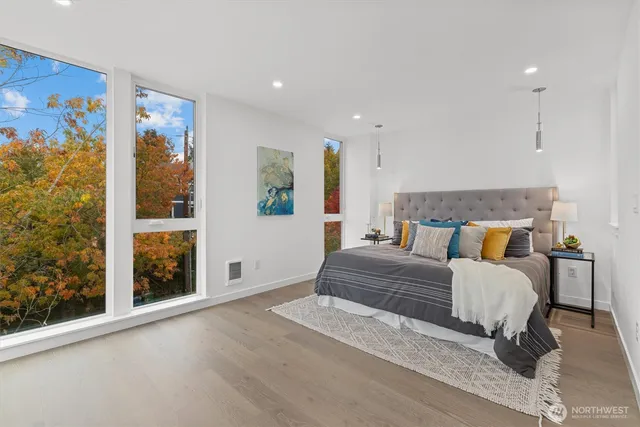 a spacious bedroom with a large bed and a window