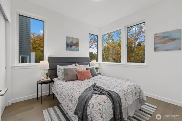 a bedroom with a bed and a painting on the wall