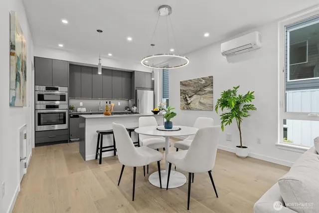 a dining room with furniture and a potted plant