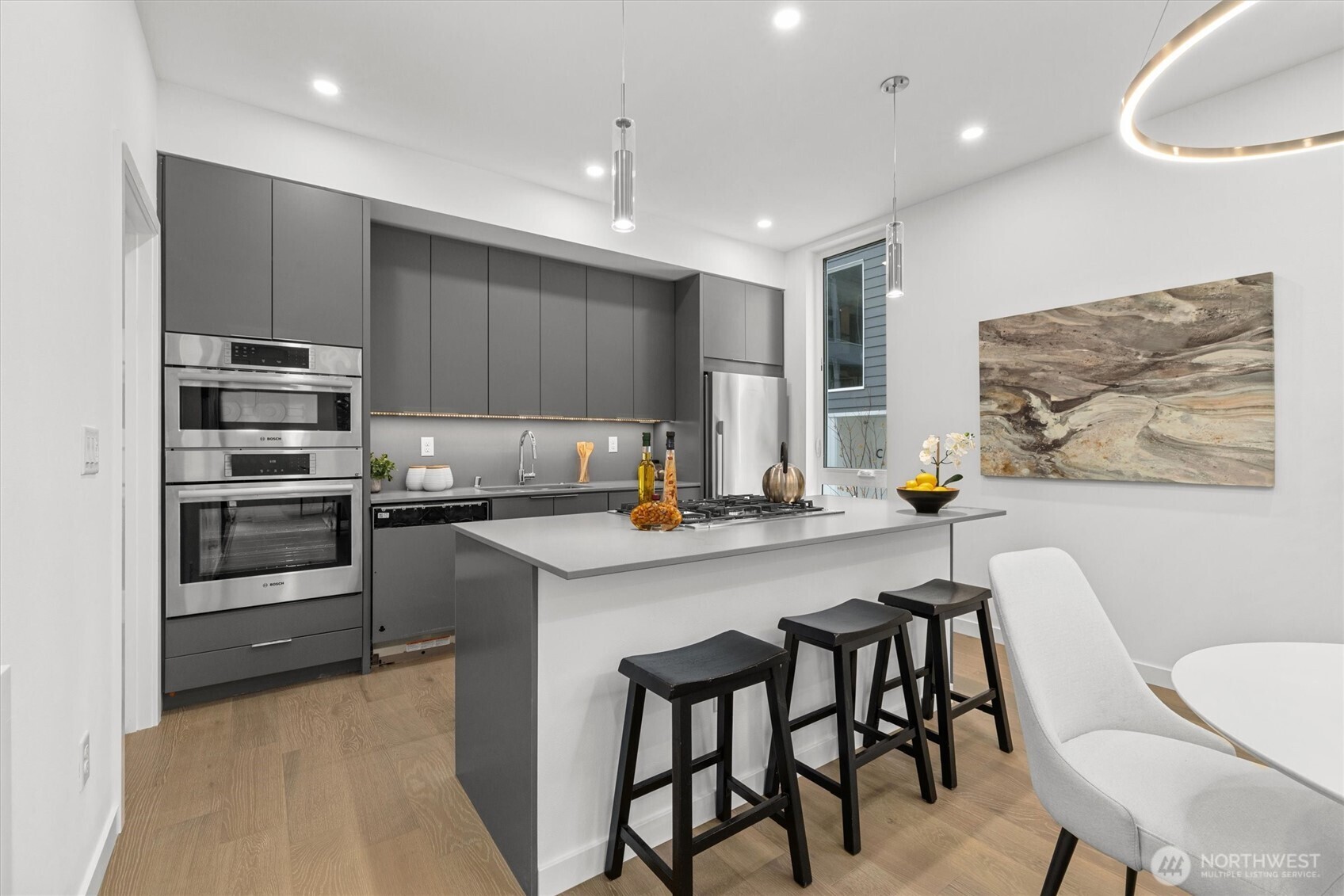 2009 South Norman Street, Unit B Seattle, WA 98144 - Photo 9 of 27 a kitchen with kitchen island a stove a table and chairs in it