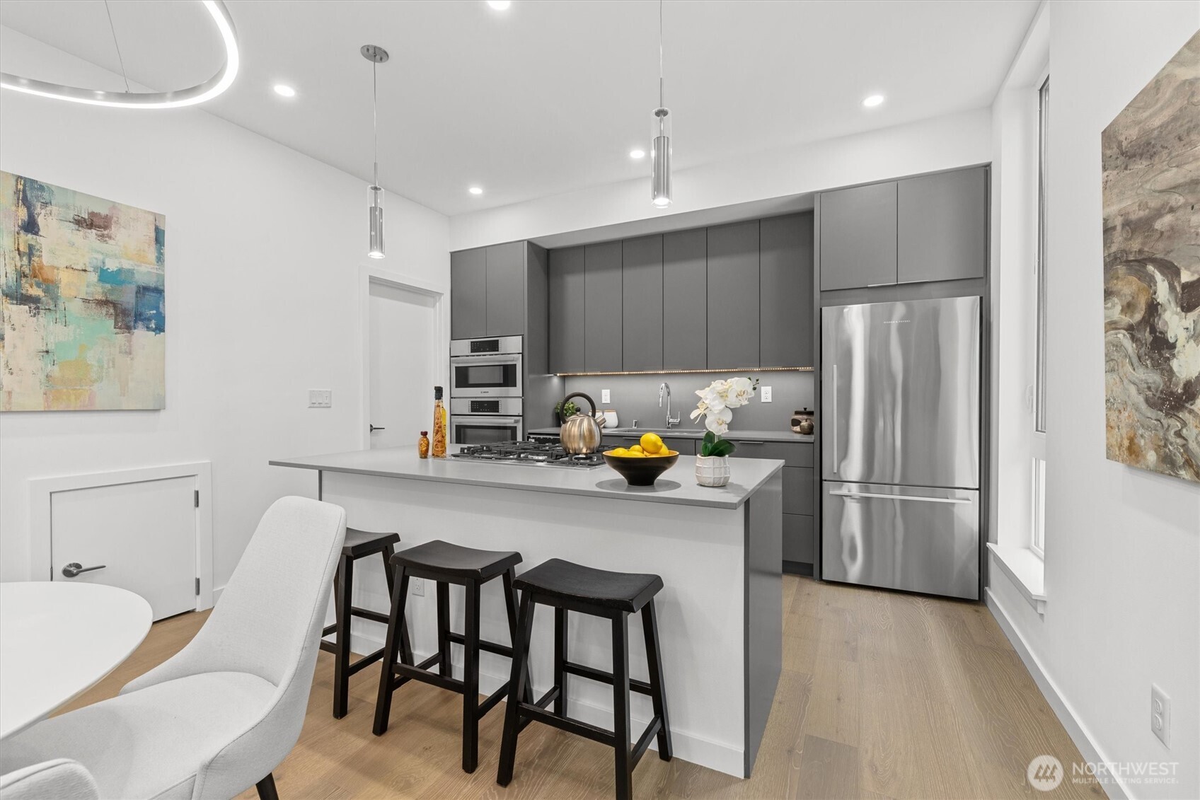 2009 South Norman Street, Unit B Seattle, WA 98144 - Photo 10 of 27 a kitchen with stainless steel appliances a refrigerator a sink a stove a dining table and chairs