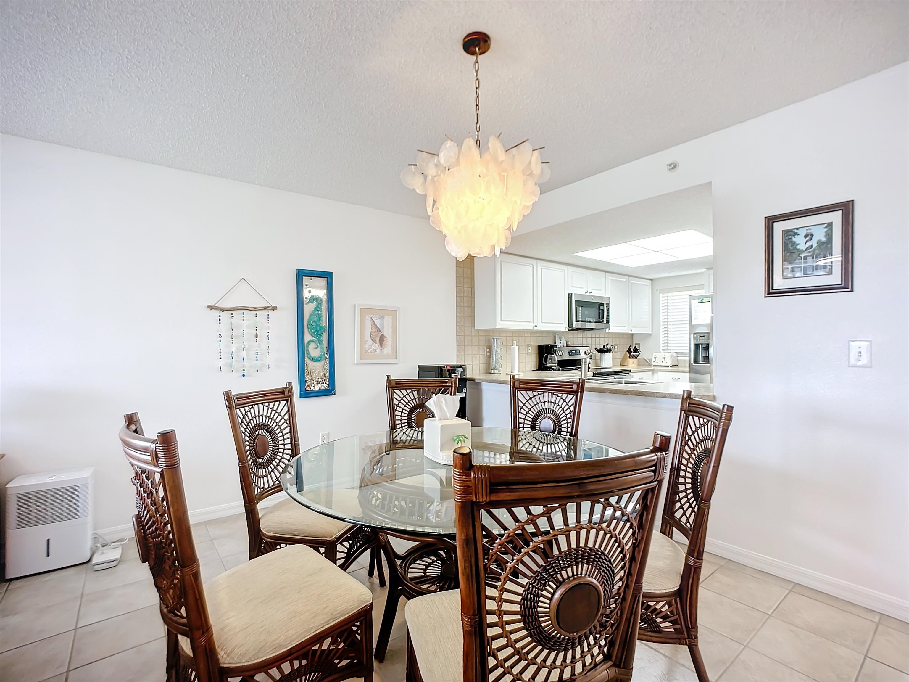 4250 A1a South Unit L-26 (elevator Bldg) St. Augustine, FL 32080 - Photo 11 of 38 a view of a dining room with furniture window and wooden floor